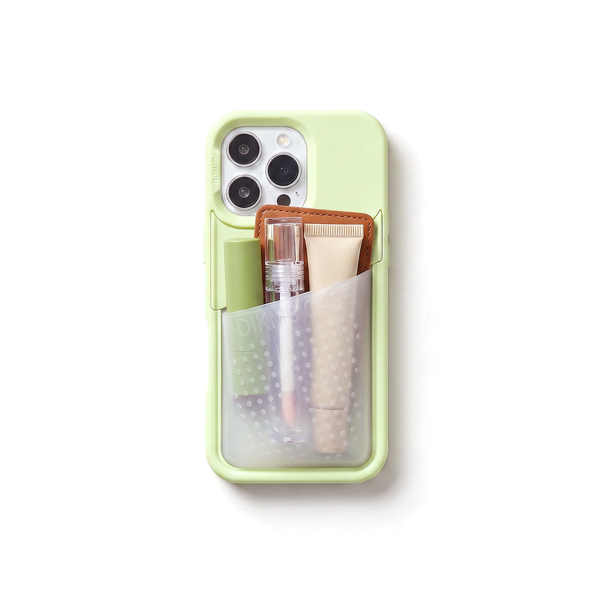 Poche pocket case in pistachio green, seen from above with the stretch pocket full